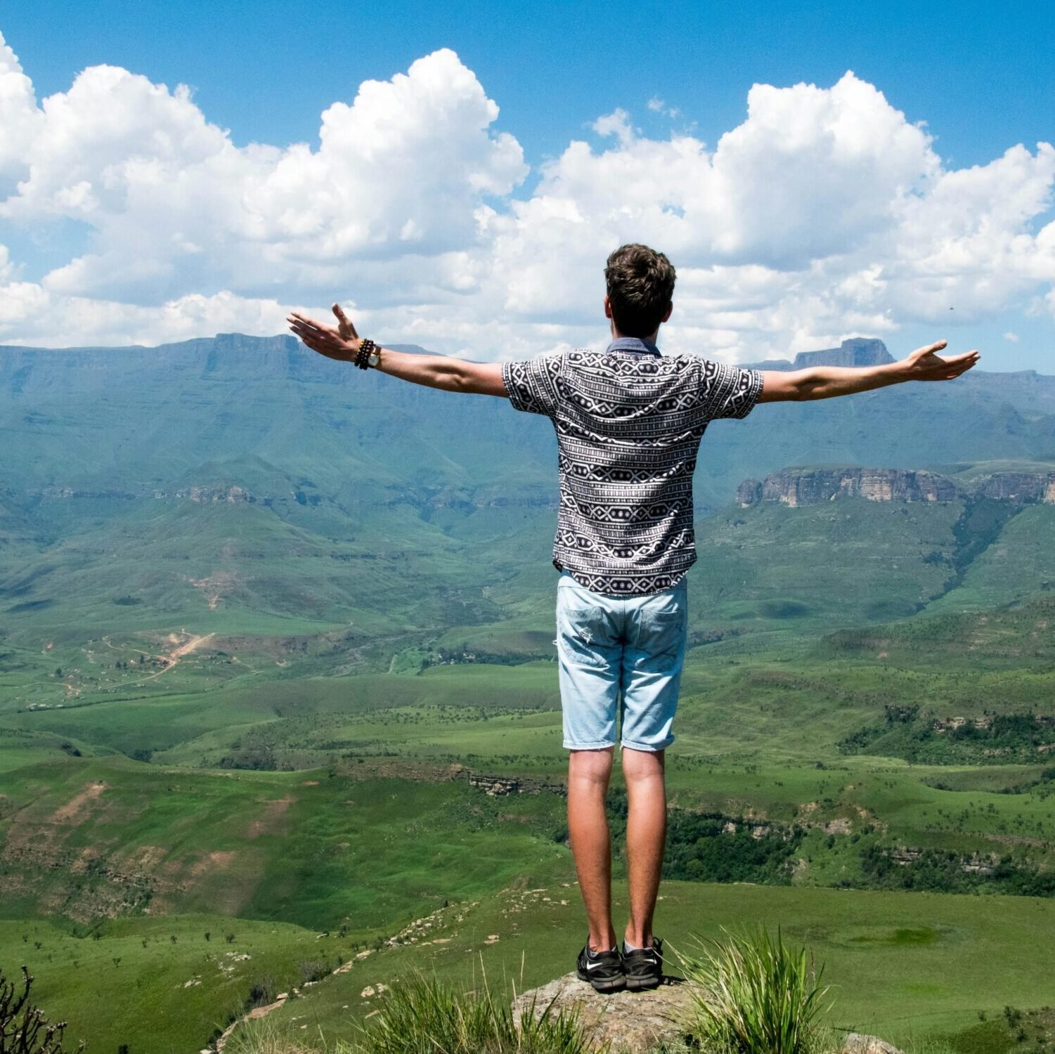 Man Wearing Grey Shirt Standing on Elevated Surface