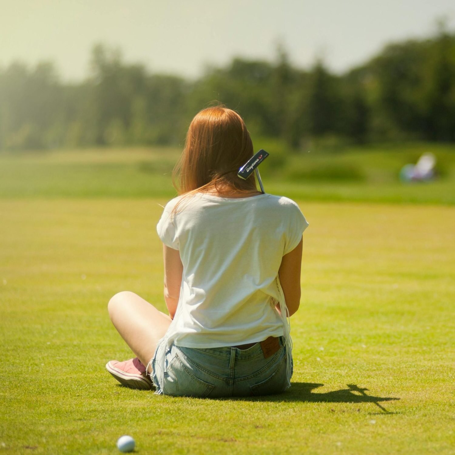 Photo of Woman Sitting on Grass Field