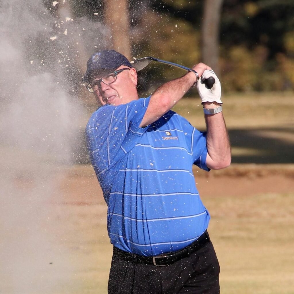 Man Hitting A Golf Ball