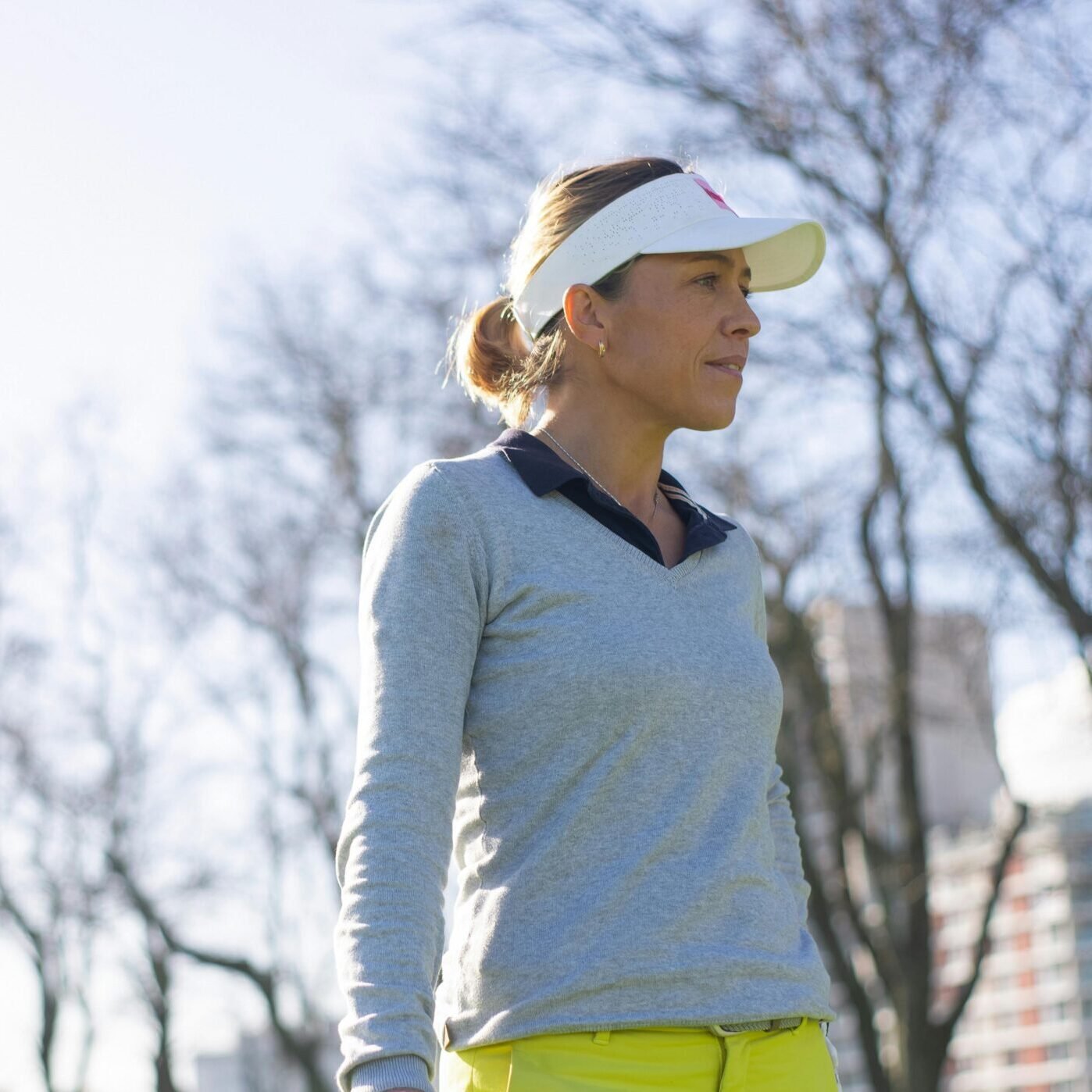 A Low Angle Shot of a Woman Wearing a White Sun Visor Cap